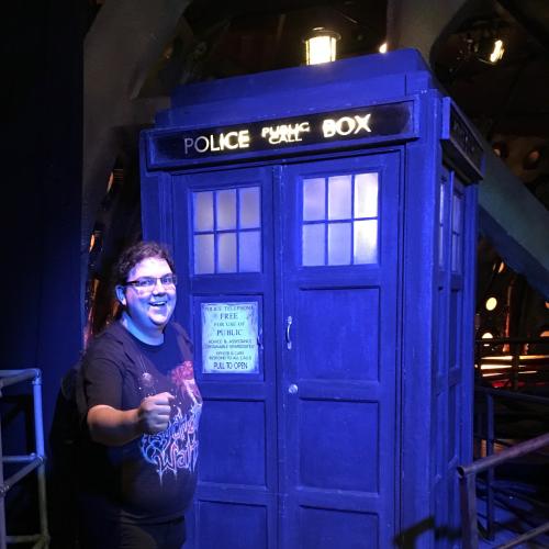 Eric’s Avatar: He, a white man with a metal t-shirt, stands in front of a blue police box. It is the TARDIS from Doctor Who.
