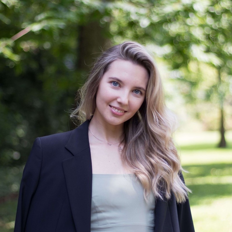 Portrait of Kristine Meldraja, a young blue-eyed girl with bright hair, smiling.